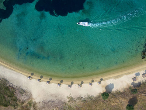 Eagles Resort Chalkidiki Drenia Island beach with sunbeds and sailing boat