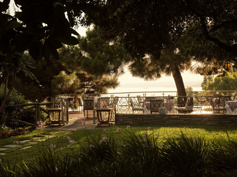 Eagles Resort Chalkidiki Kamares Restaurant garden with lawn and pine trees